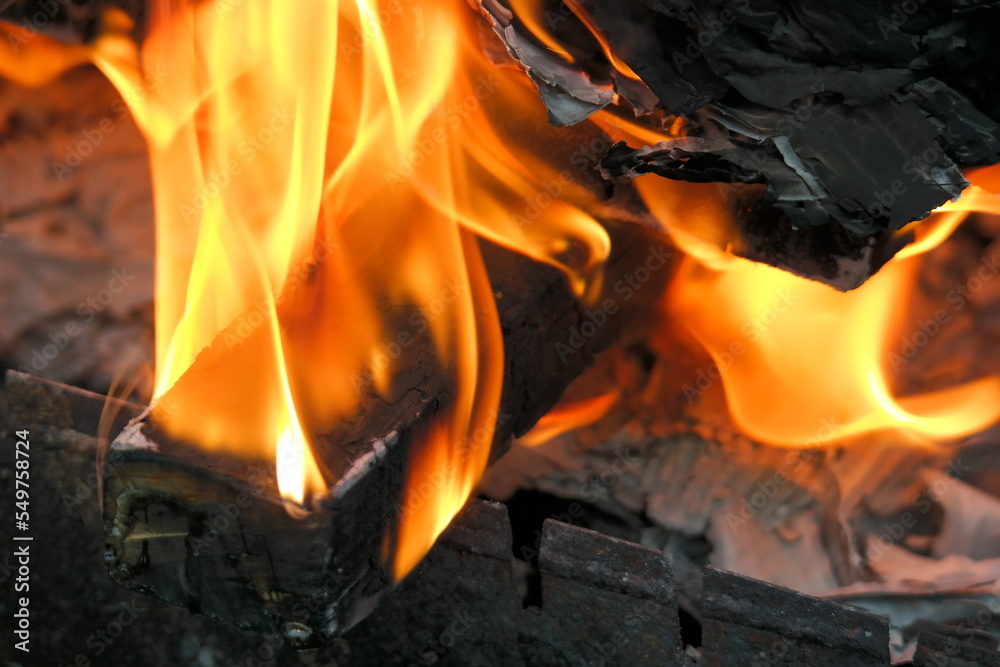 burning wood and paper. firewood is burning. tongues of flame. orange