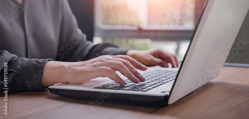 Closeup woman hands typing on laptop computer, businesswoman or student girl using laptop at home, online learning, internet marketing, working from home, office workplace freelance concept.