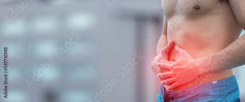 Man hold hands in painful areas which may be caused by gastritis, abdominal pain. Hands man holding his stomach in pain photo