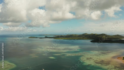 Tropical islands with turquoise coral reef water under a blue sky with clouds, aerial drone. Bucas grande, Philippines. Summer and travel vacation concept. photo