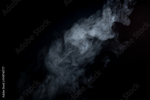 Closeup shot of white smoke on the black background