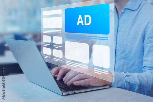 Programmatic in-feed advertisement on computer screen. Person viewing website with inbound ads to optimize click through rate and conversion. Digital marketing and online advertising to target client.