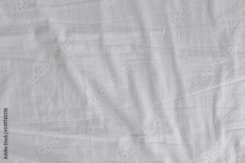 Wrinkled white bed sheets in the bedroom as background