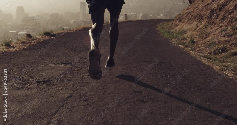 Running, mountain and feet of sports man for outdoor fitness, exercise and speed challenge in morning with sneakers. Asphalt road, runner or athlete black man with fast, power and muscle in his legs