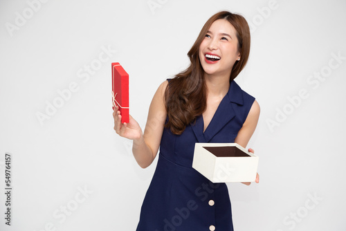 Bild auf Leinwand Happy beautiful Asian woman opening gift box isolated on white background