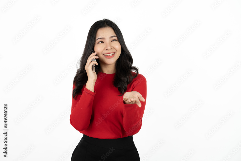 Smiling charming Asian woman uses mobile phone happy texting in social networks addicted to modern technologies isolated over white background. Online communication. Smiling charming Asian woman uses mobile phone happy texting in social networks addicted to modern technologies isolated over white background. Online communication.