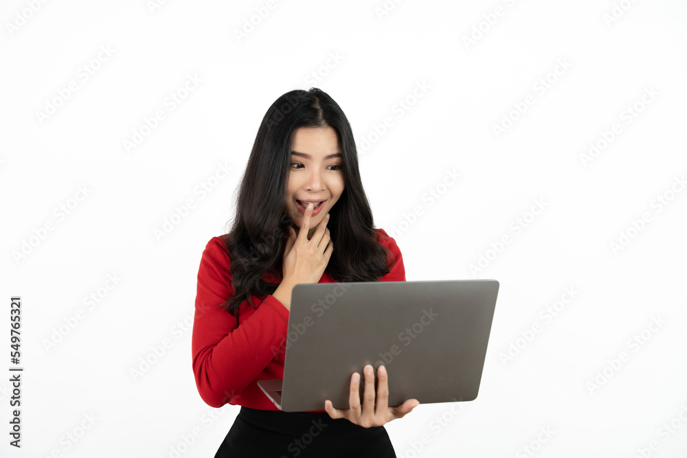 Happy asian business woman holding laptop computer and looking at the camera over white background. Happy asian business woman holding laptop computer and looking at the camera over white background.