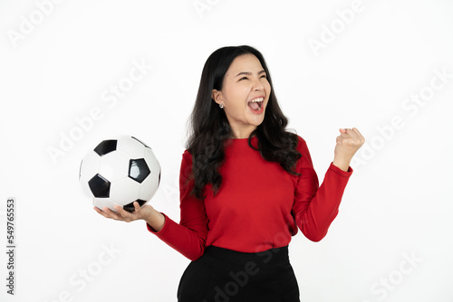Happy Asian woman football fan cheer up support favorite team with soccer ball isolated on white background.