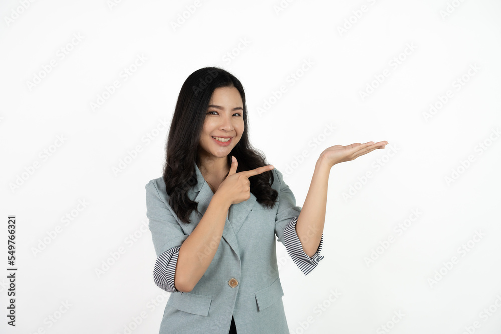 Asian business woman isolated on white background pointing to the side to present a product. Asian business woman isolated on white background pointing to the side to present a product.