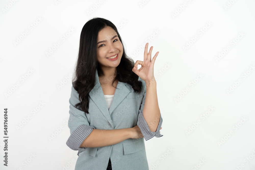 Portrait happy Asian woman shows ok sign and looking at the camera on white background. Portrait happy Asian woman shows ok sign and looking at the camera on white background.