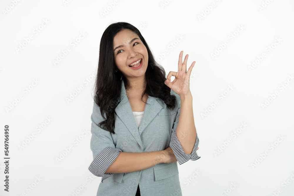 Portrait happy Asian woman shows ok sign and looking at the camera on white background. Portrait happy Asian woman shows ok sign and looking at the camera on white background.