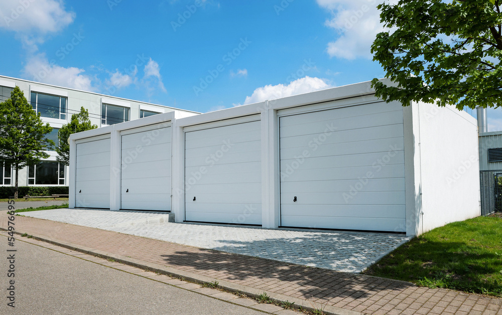 Four modern white free standing garages with sectional door with modern