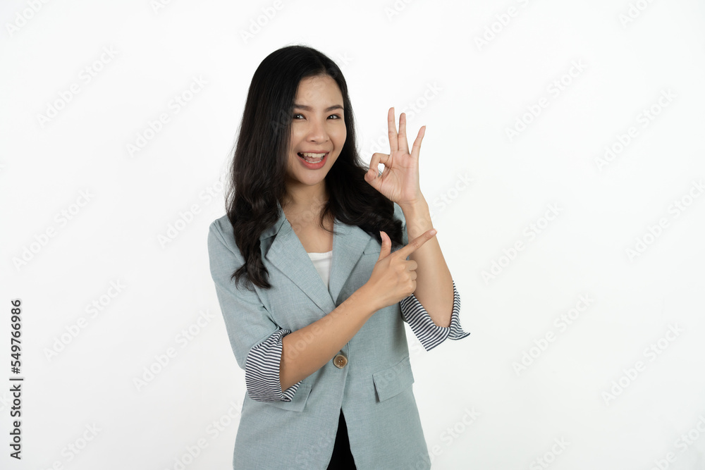 Portrait happy Asian woman shows ok sign and looking at the camera on white background. Portrait happy Asian woman shows ok sign and looking at the camera on white background.
