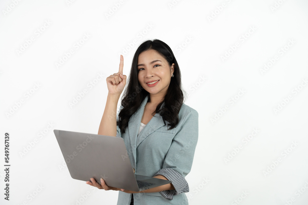Happy asian business woman holding laptop computer and looking at the camera over white background. Happy asian business woman holding laptop computer and looking at the camera over white background.