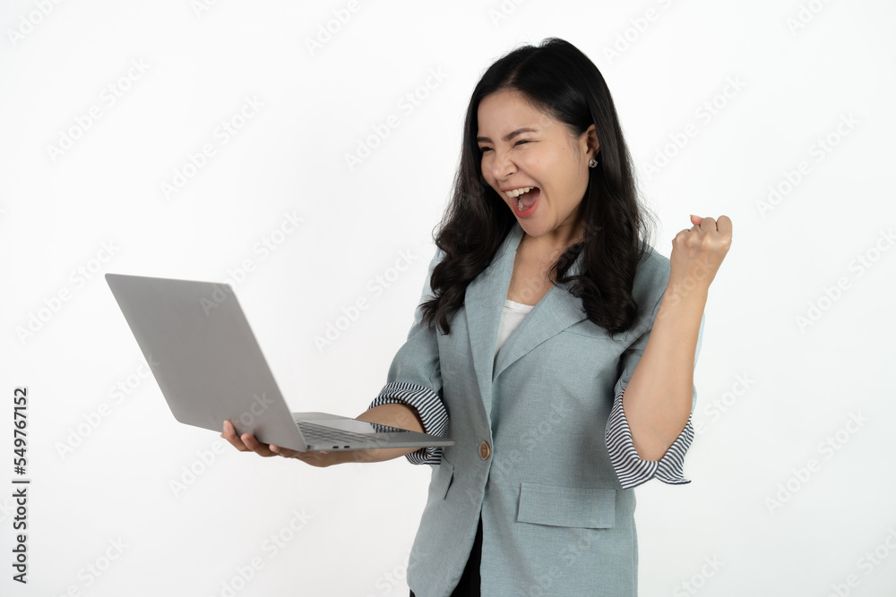 Happy asian business woman holding laptop computer and looking at the camera over white background. Happy asian business woman holding laptop computer and looking at the camera over white background.