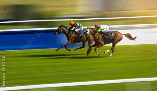 Obraz na plátne Two jockeys compete to win the race