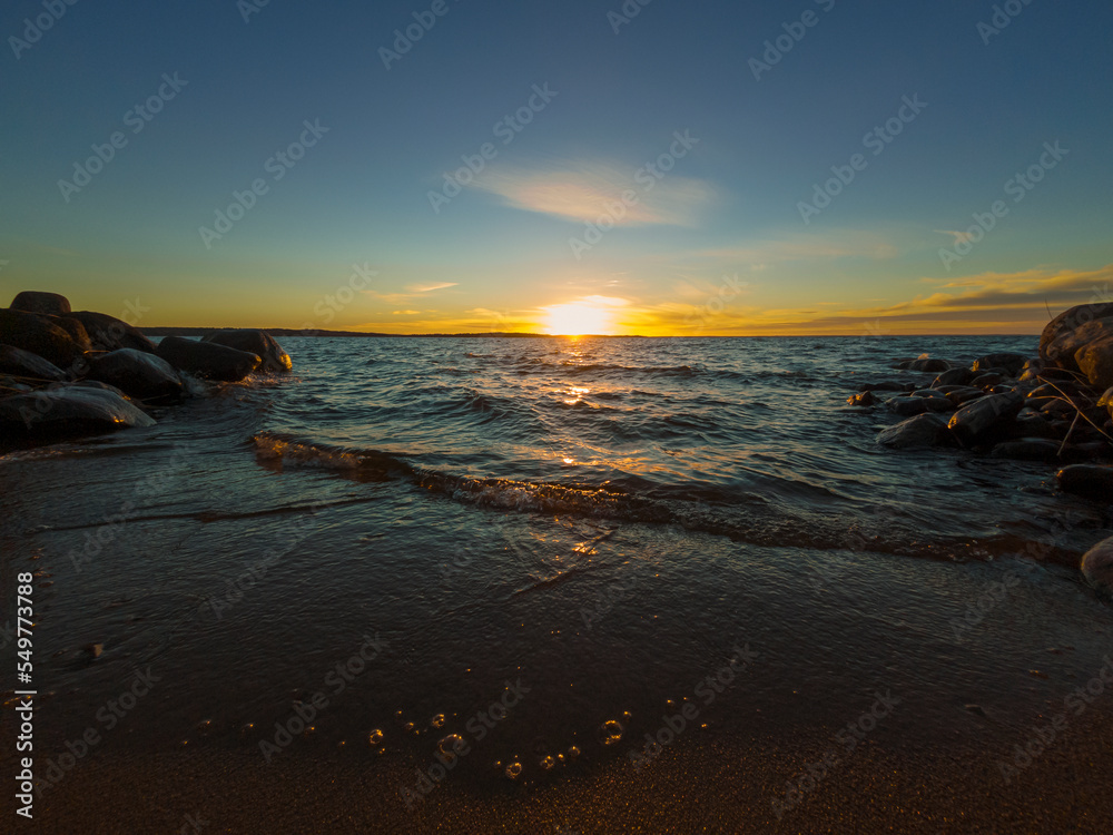 	Autumn nature landscape. Sunset on sandy beach of large forest lake