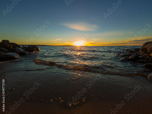  Autumn nature landscape. Sunset on sandy beach of large forest lake