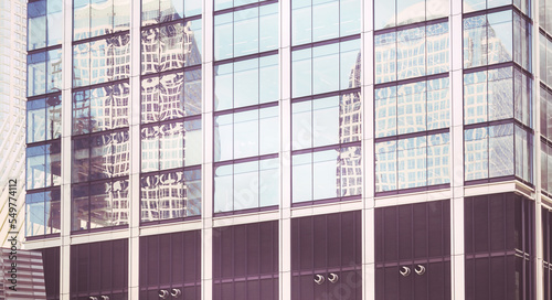 Buildings reflected in windows of a modern skyscraper  abstract urban background  color toning applied  New York City  USA.