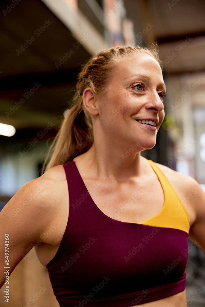 Smiling woman standing in a gym Smiling woman standing in a gym