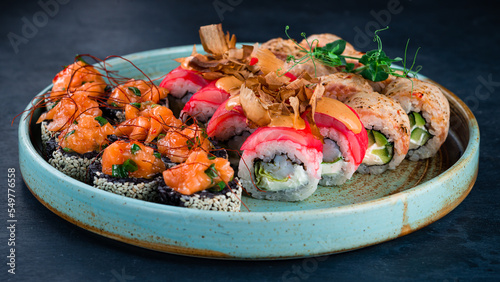 Set of fresh japanese sushi rolls with tuna, sea bass, salmon, cucumber, avocado and cream cheese.