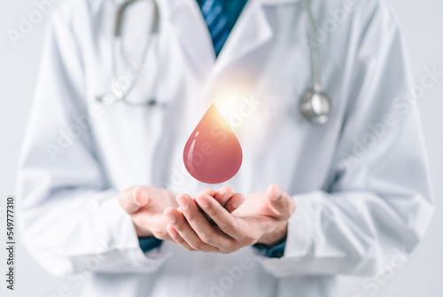 doctor in a white coat receive blood donation, blood transfusion, world blood donor day, red cross to give blood.world hemophilia day concept. photo