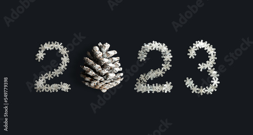 Numbers 2023 made of confetti snowflakes and cone on dark background. Figures of new year