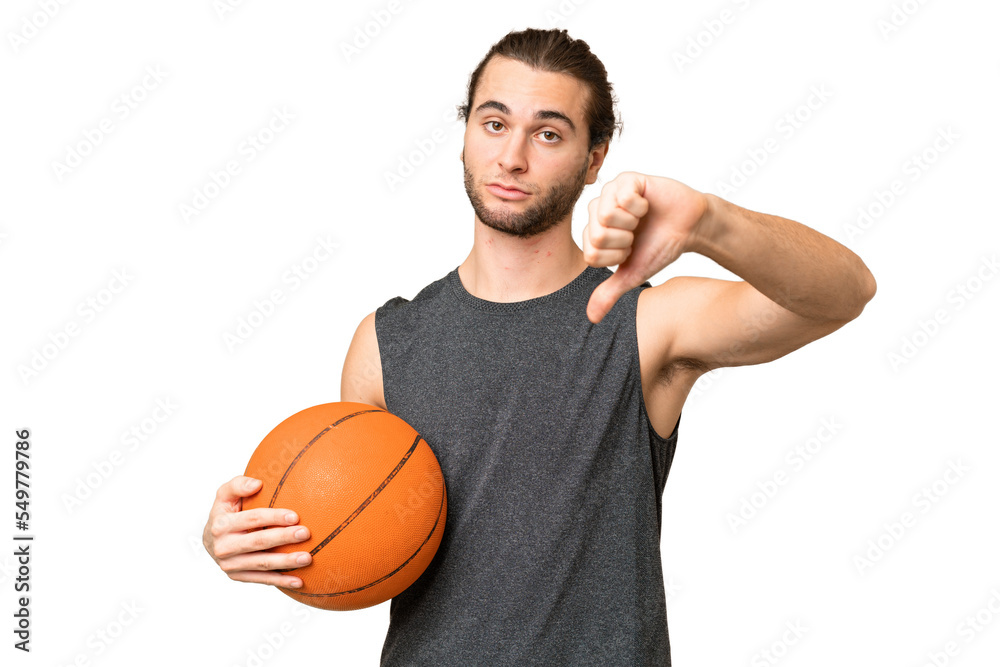 Obraz premium Young basketball player man over isolated background showing thumb down with negative expression
