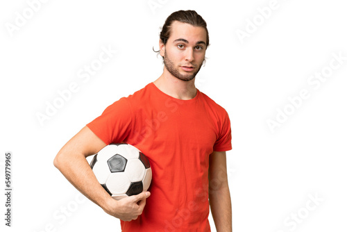 Young handsome man isolated on green chroma background with soccer ball