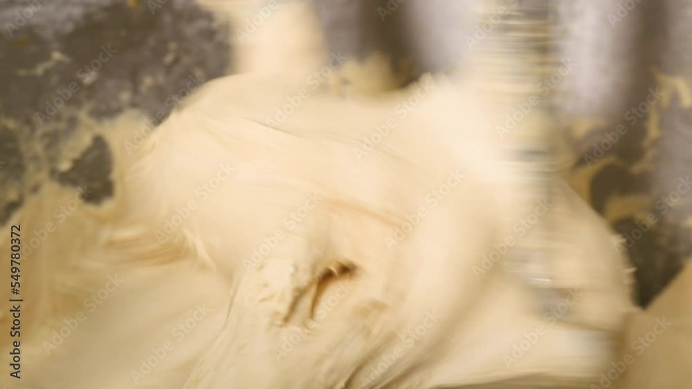 Close up of dough in electric bakery mixer. High quality 4k footage Close up of dough in electric bakery mixer. High quality 4k footage