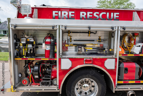 Fire engine with equipment storage bins open