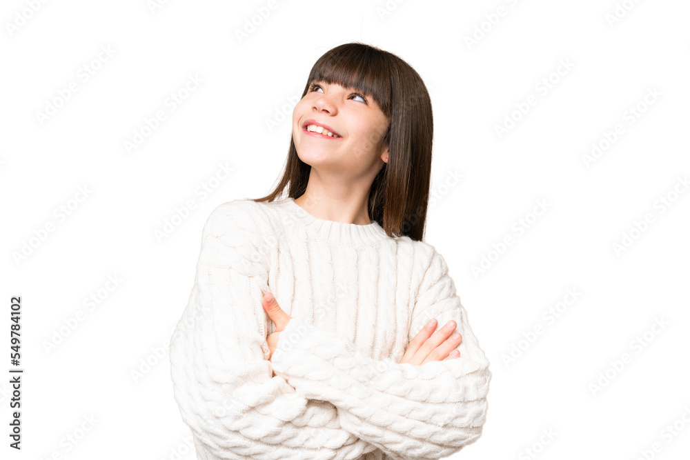 Little caucasian girl over isolated background looking up while smiling