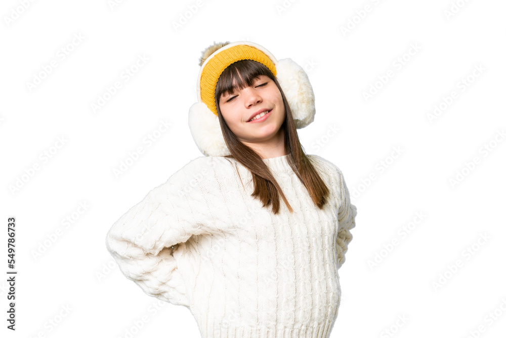 Little caucasian girl wearing winter muffs over isolated background suffering from backache for having made an effort