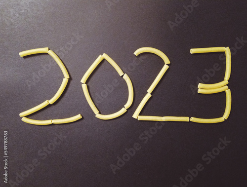 2023 written in pasta on black background