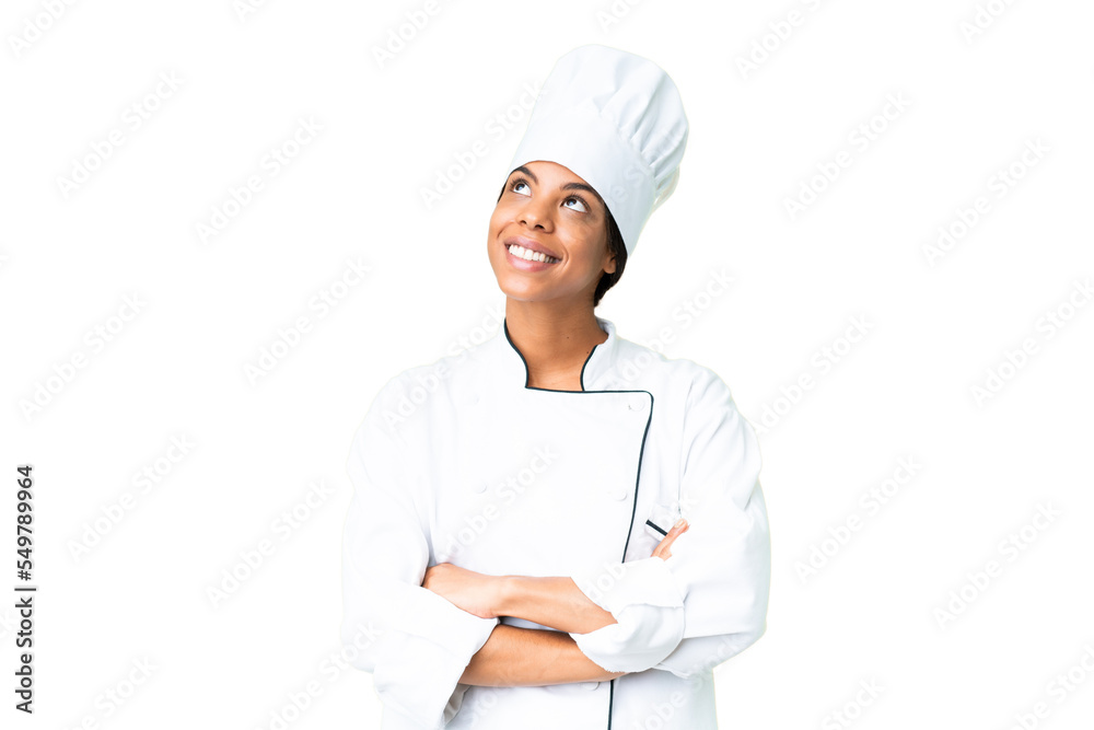 Young African American chef over isolated chroma key background looking up while smiling Young African American chef over isolated chroma key background looking up while smiling