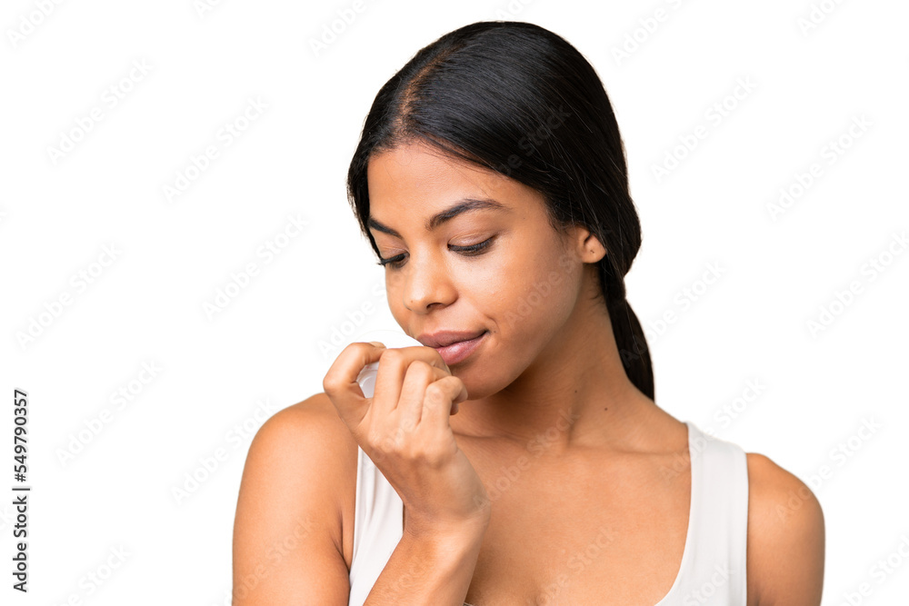 Young woman over over isolated chroma key background with moisturizer and smelling it Young woman over over isolated chroma key background with moisturizer and smelling it
