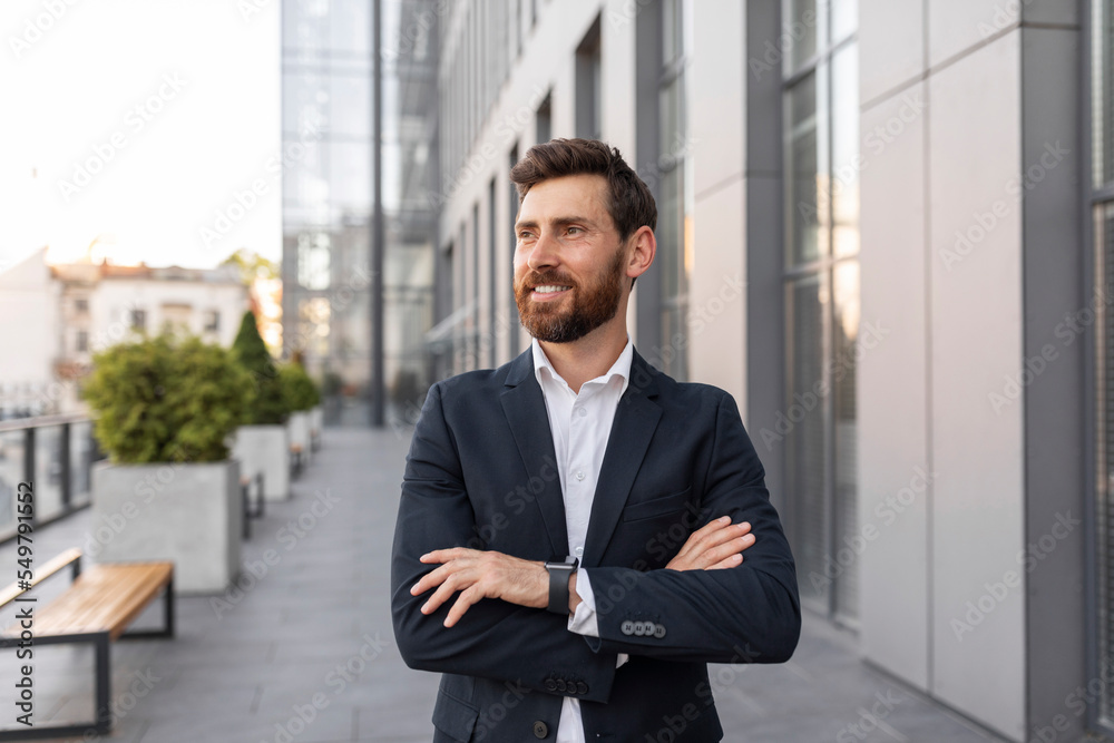 Glad confident handsome young european male ceo manager or general director with beard in suit Glad confident handsome young european male ceo manager or general director with beard in suit