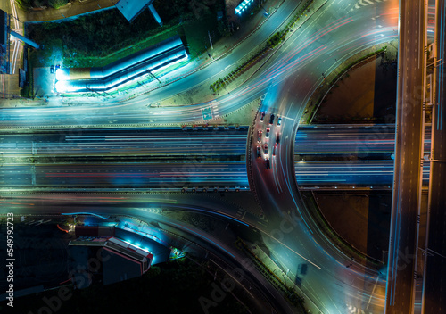 Expressway top view, Road traffic an important infrastructure, car traffic transportation above intersection road in city night, aerial view cityscape of advanced innovation, financial technology 