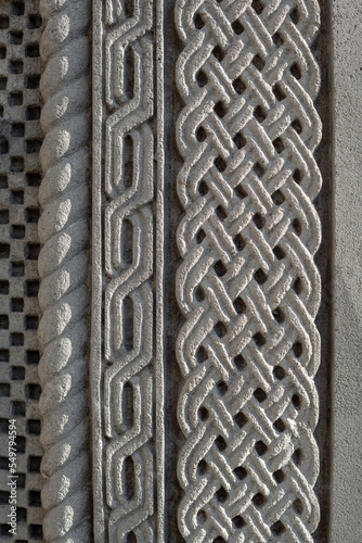 part of the decor and the material from which it is made;
part of the pattern on the old wall is carved from stone
