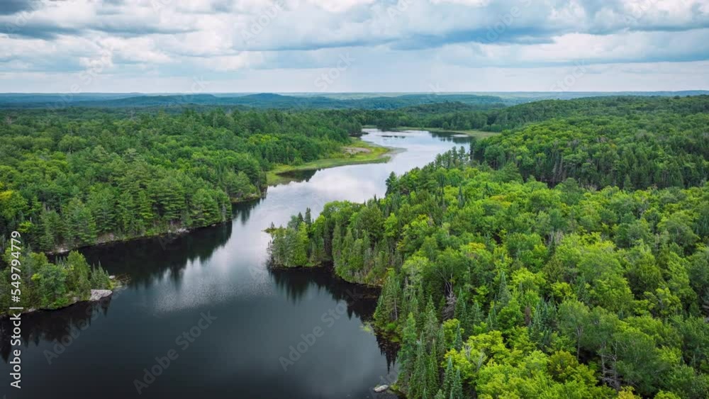 Forward motion hyper lapse with clouds over a river and forest in summer