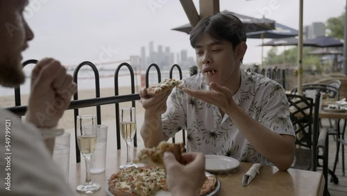 Gay couple enjoying pizza