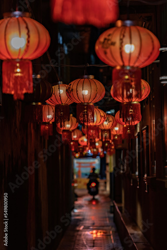 Chinese lanterns on the street at night, China town, Chinese new year decoration. TRANSLATION FROM CHINESE: Happy New Year © Natalia