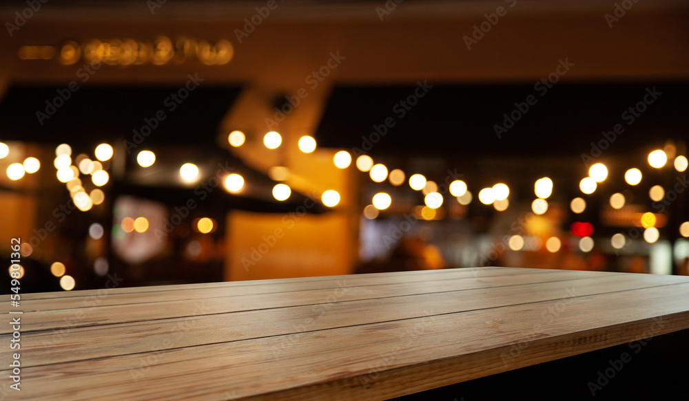 dark blurred background with empty table top, cafe restaurant windows. background for your product