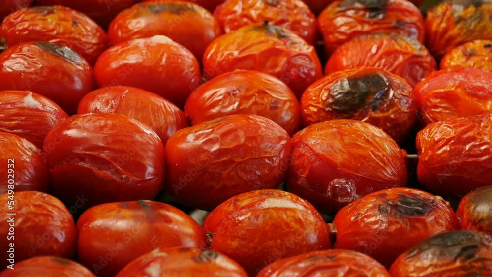 grilled tomatoes are turned on skewers close-up grilled tomatoes are turned on skewers close-up