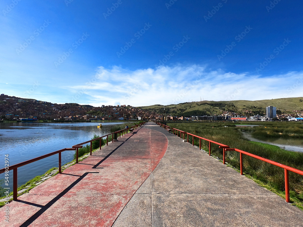 Sunny view of Lake Titicaca and the Peruvian city of Puno