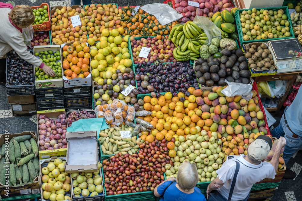 heaps of colorful fruits on sale on stall at covered market, Funchal, Madeira
