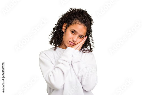Young Brazilian curly hair cute woman isolated yawning showing a tired gesture covering mouth with hand. © Asier