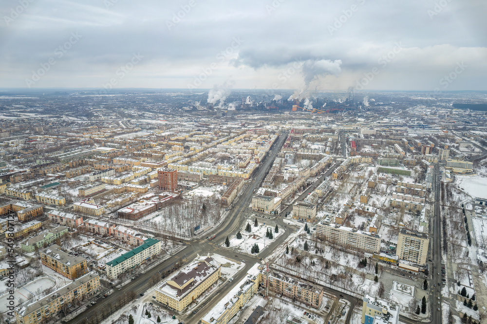 Winter view of the center of the city of Nizhny Tagil and the metallurgical plant from above. Environmental problem of environmental pollution and air in large cities