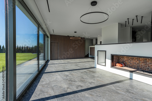 empty space of a country house with large panoramic windows for renting real estate, a green lawn outside the window