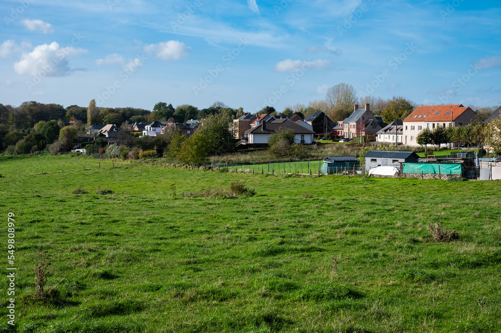 Asse, Flemish Brabant Region, Belgium - Scenic view over green hills and meadows ith residential houses in the background Asse, Flemish Brabant Region, Belgium - Scenic view over green hills and meadows ith residential houses in the background